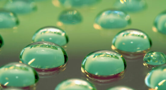 Glycerine drops on a green glass plate