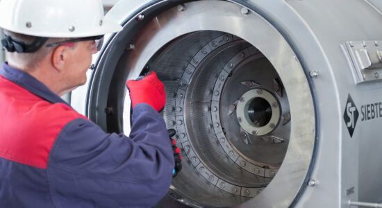 Centrifuge service / maintenance. Fitter replaces slotted screens