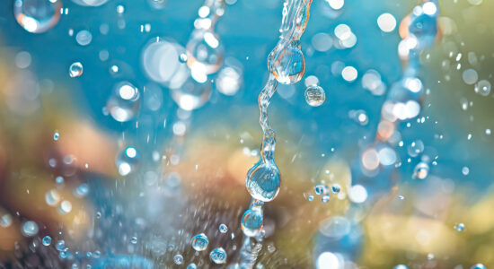 Water filtration, water droplets and air bubbles splash through a slotted filter